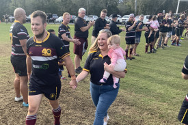 In honour of his 100th appearance for the Caboolture Snakes, John Flew leads the team onto the arena along with wife Tia and daughter Stevie.