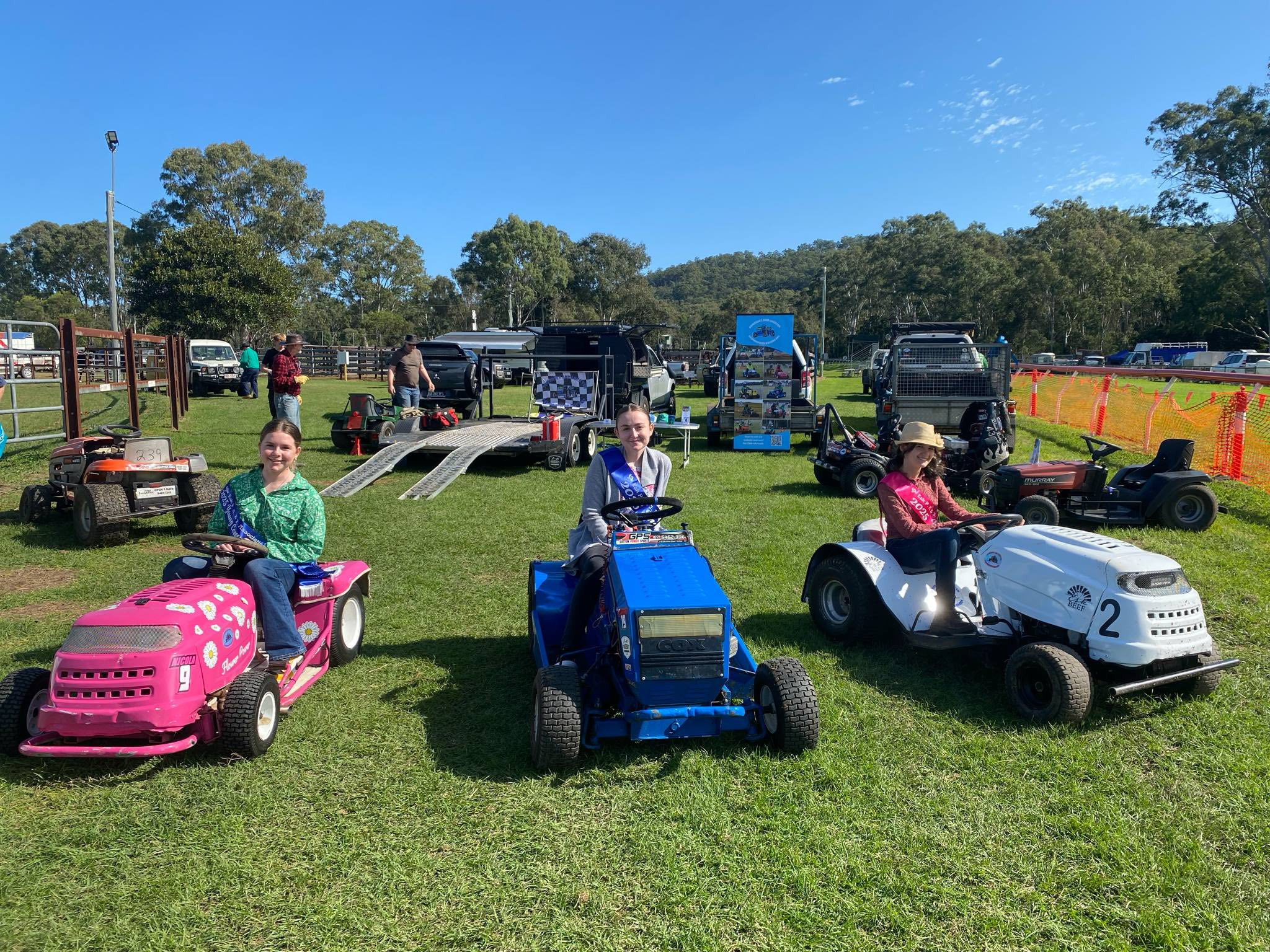 2025 Young Community Leader, Tayla Porter, Esk Showgirl, Taleah Pearson, and Show Princess, Nikita Brown, kicking off lawn mower racing. Photo: Esk Show Society.