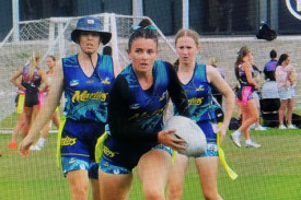 Ayvah Latham shows her ball skills for the Metro North Marlins U17 girls team while her sister Rihanna (left) looks on, at the national oztag championships in Coffs Harbour.