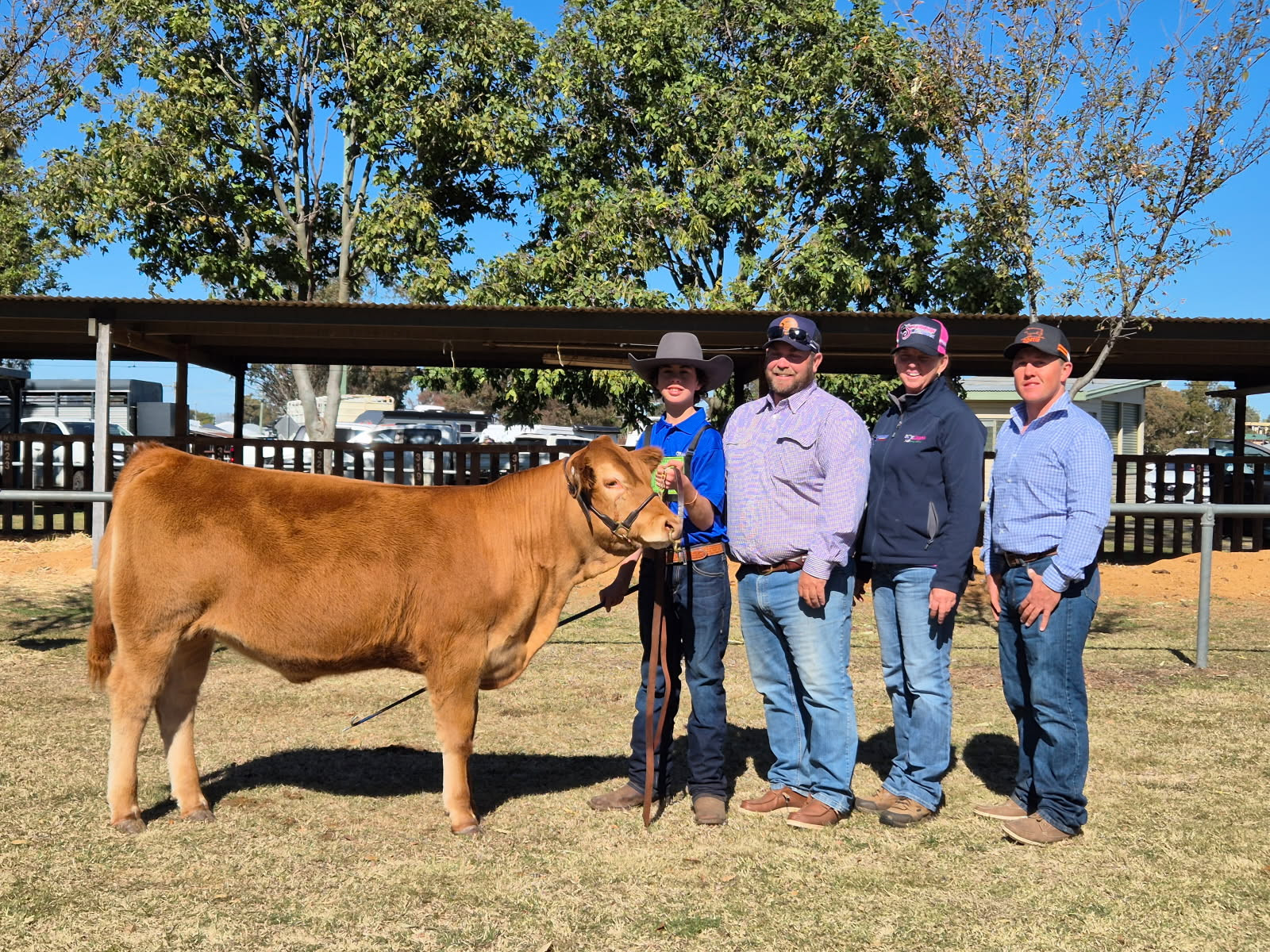 Dusty with his scholarship prize heifer and judges
