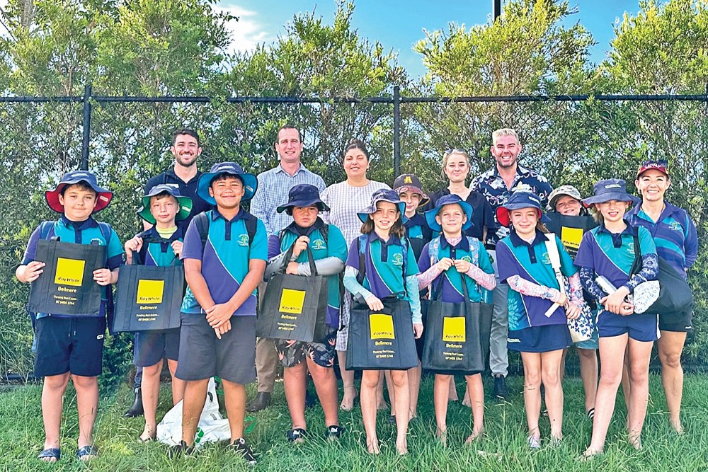 Students from Bellmere State School (front) with staff from Ray White Wamuran | Bellmere (back)