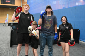 Spider Boxing students Jayden, Hayden and Erin with coach Alex.