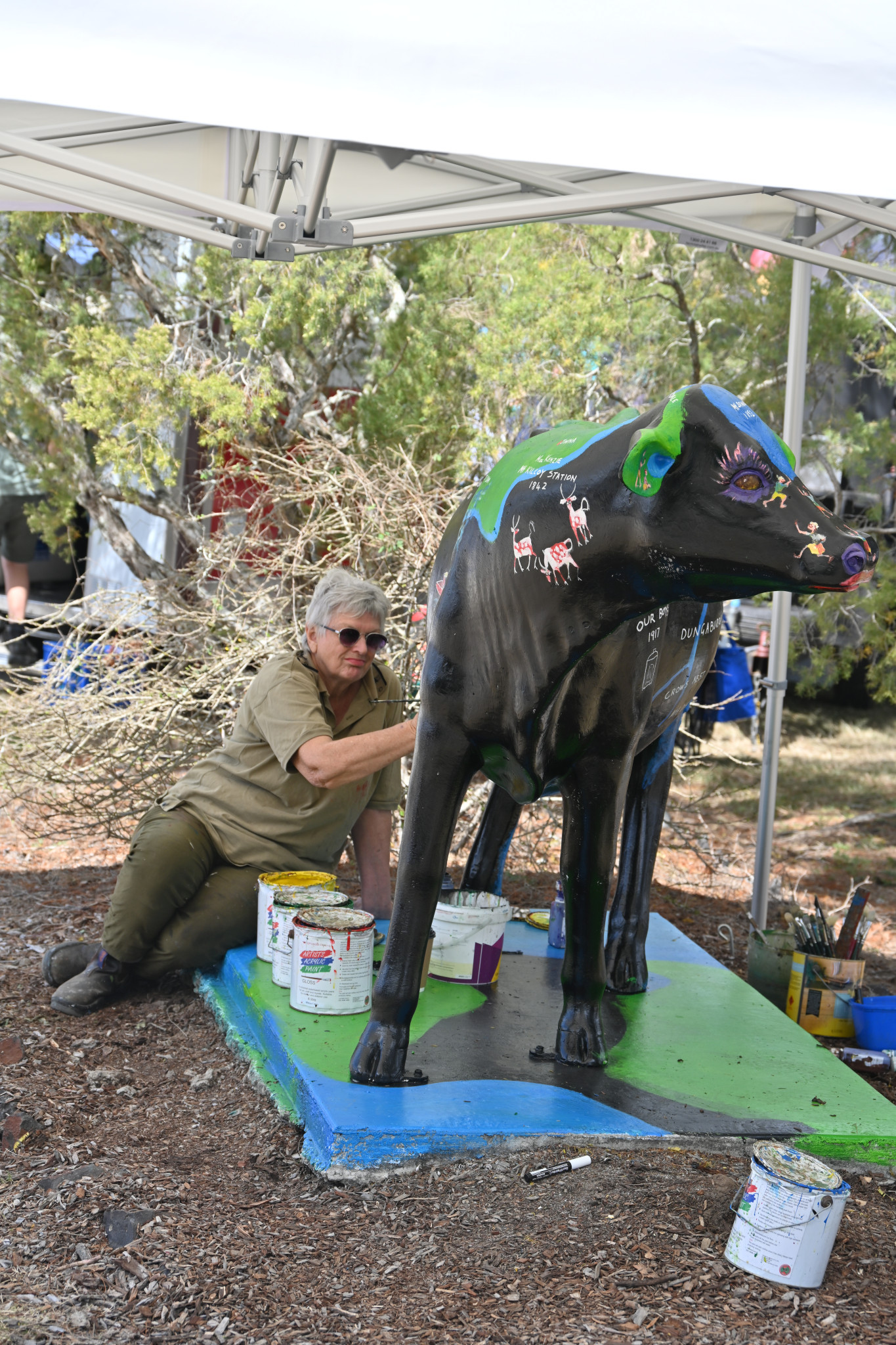 Artist Susan McConnel repainting the museum’s cow.
