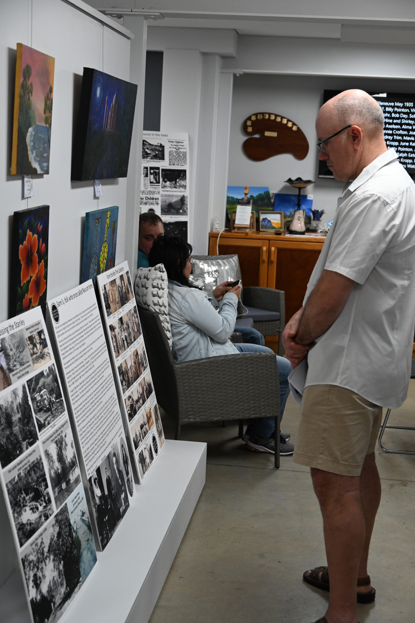 2024 reunion attendee appreciating history posters.