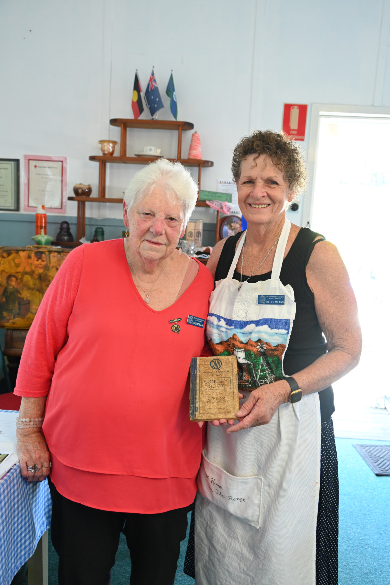 QCWA members with vintage cookbook.