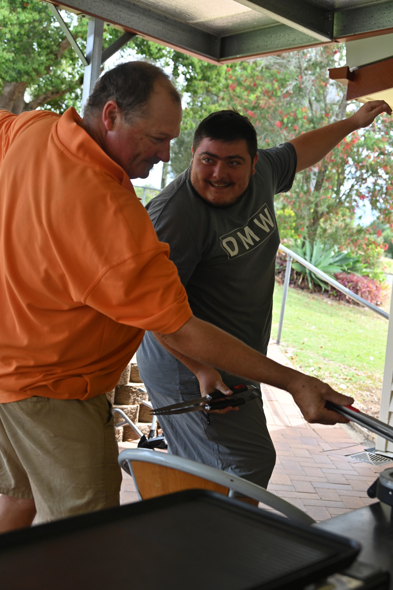 Mark and Mat flipping sausages.