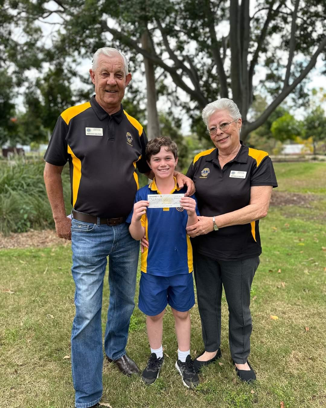 Jack Fortnum (centre) receives a cheque from Wamuran Lions duo Howard Walters and Michelle Kalms, to go towards Jack’s upcoming soccer stint in England.