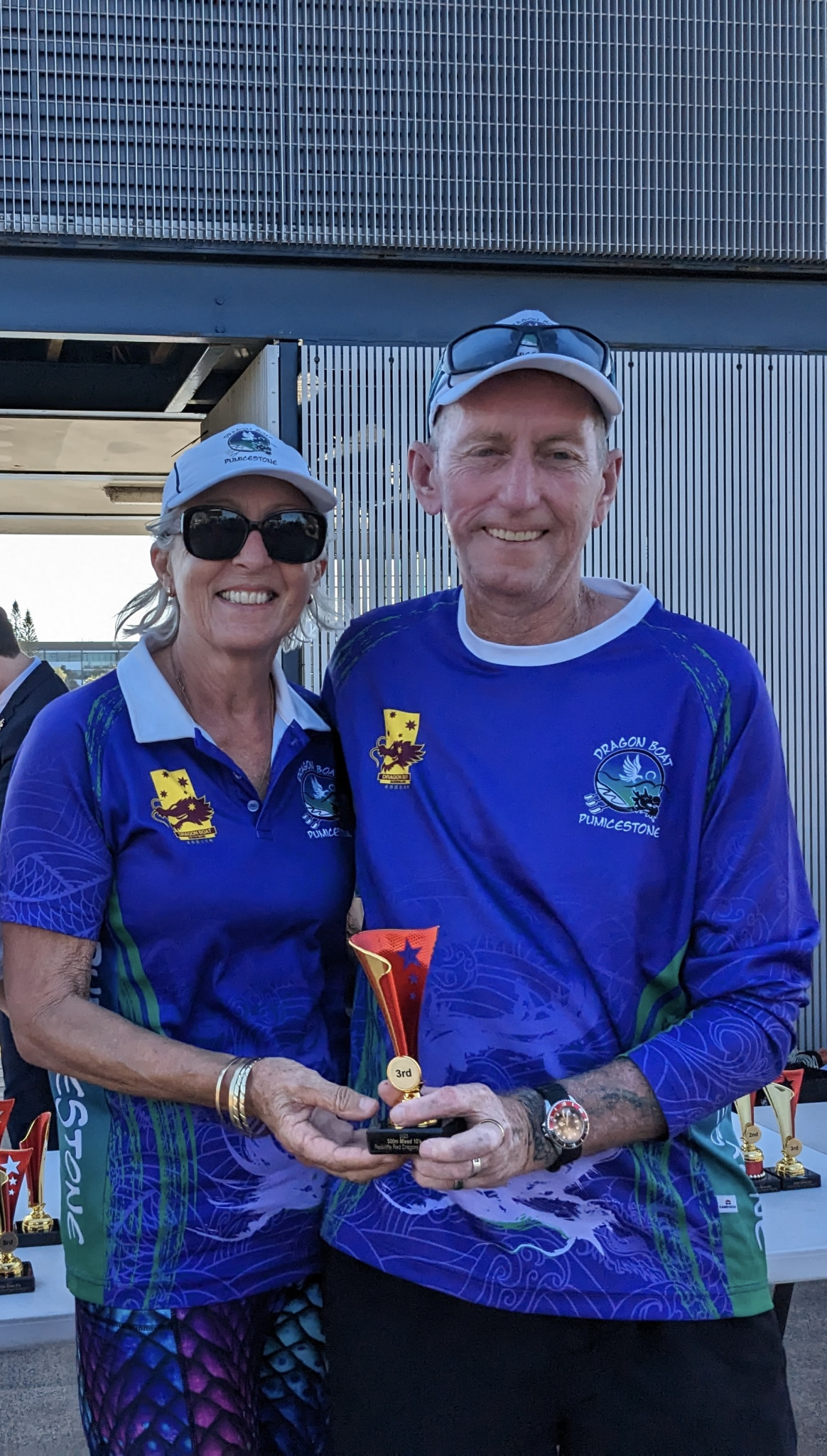 Janet Johns and Martin Kinross with a trophy for the Dragon Boat Pumicestone Mixed Team.