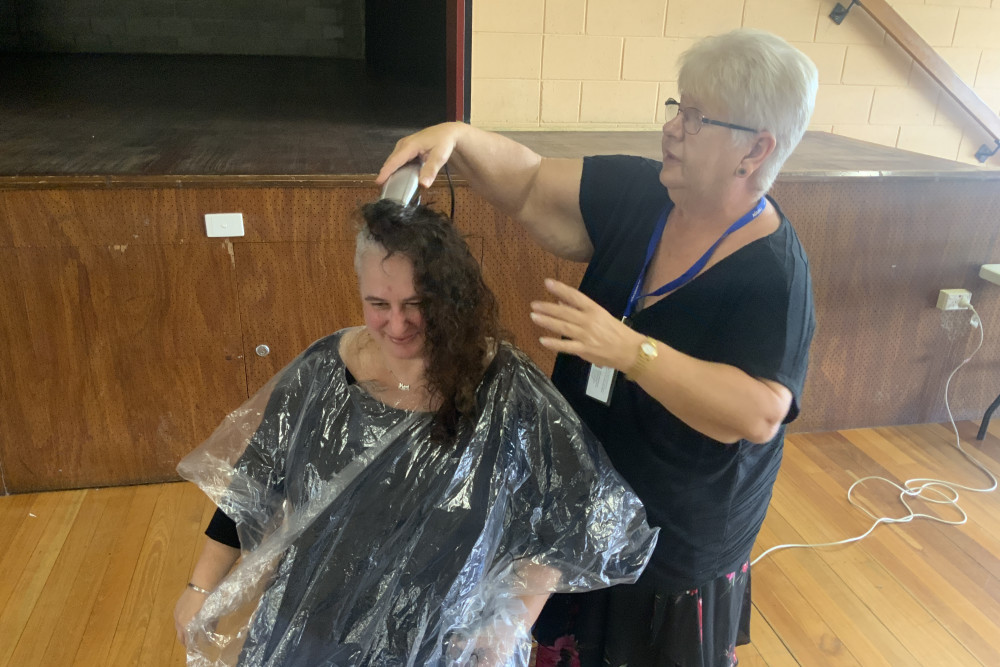 Nicola Bratley has her head shaved, with Gaylene Smith the acting hairdresser.