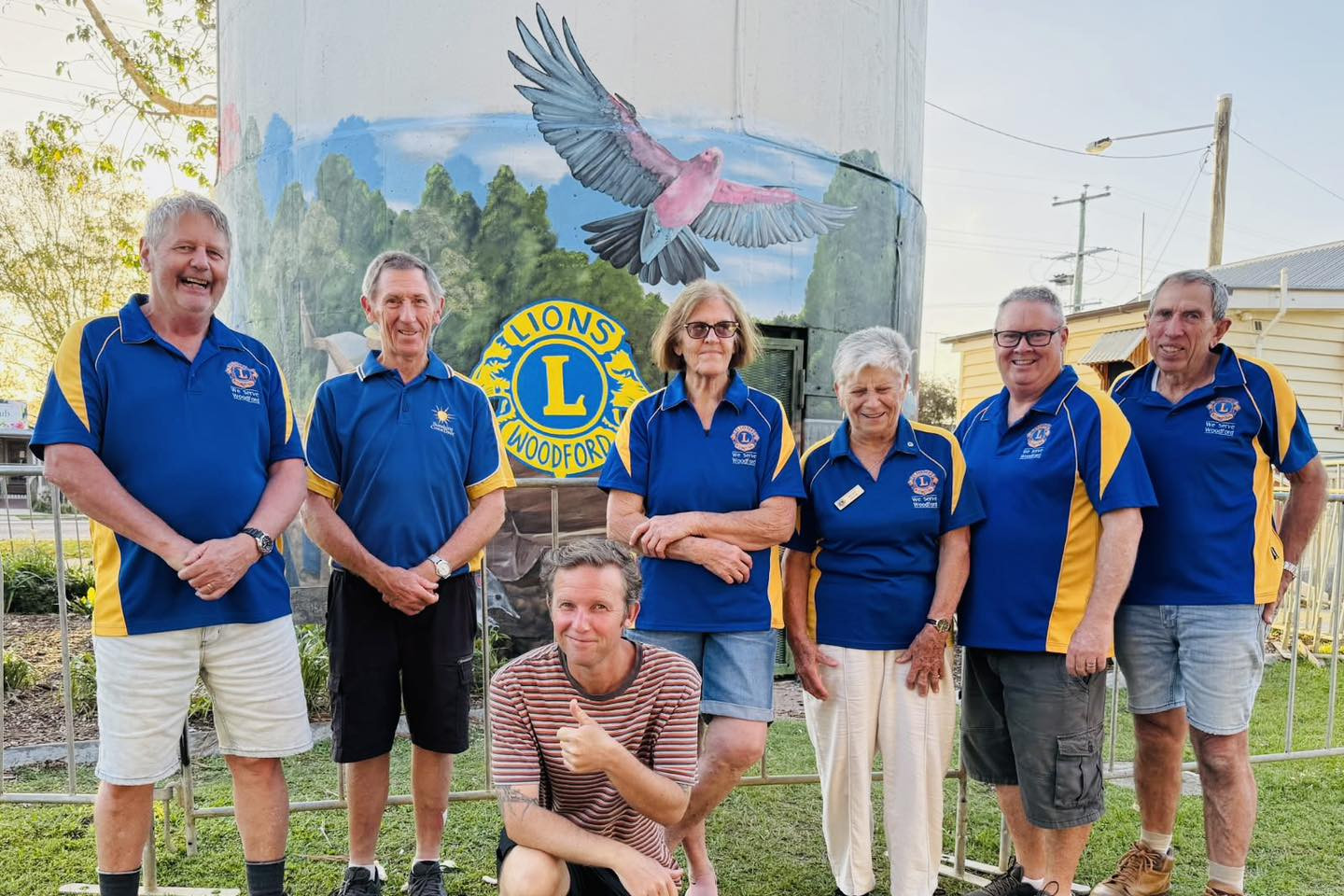 Woodford Lions with artist Ben Higgins in front of new mural. Photos: Woodford Lions Club