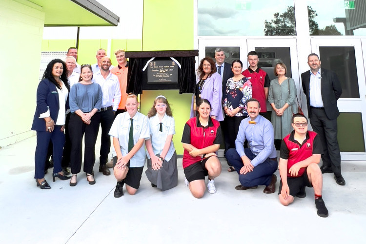 Local politicians and students and staff from the Lee Street Special School in Caboolture and the Caboolture State High School celebrate the opening of a new hall which the schools will share.