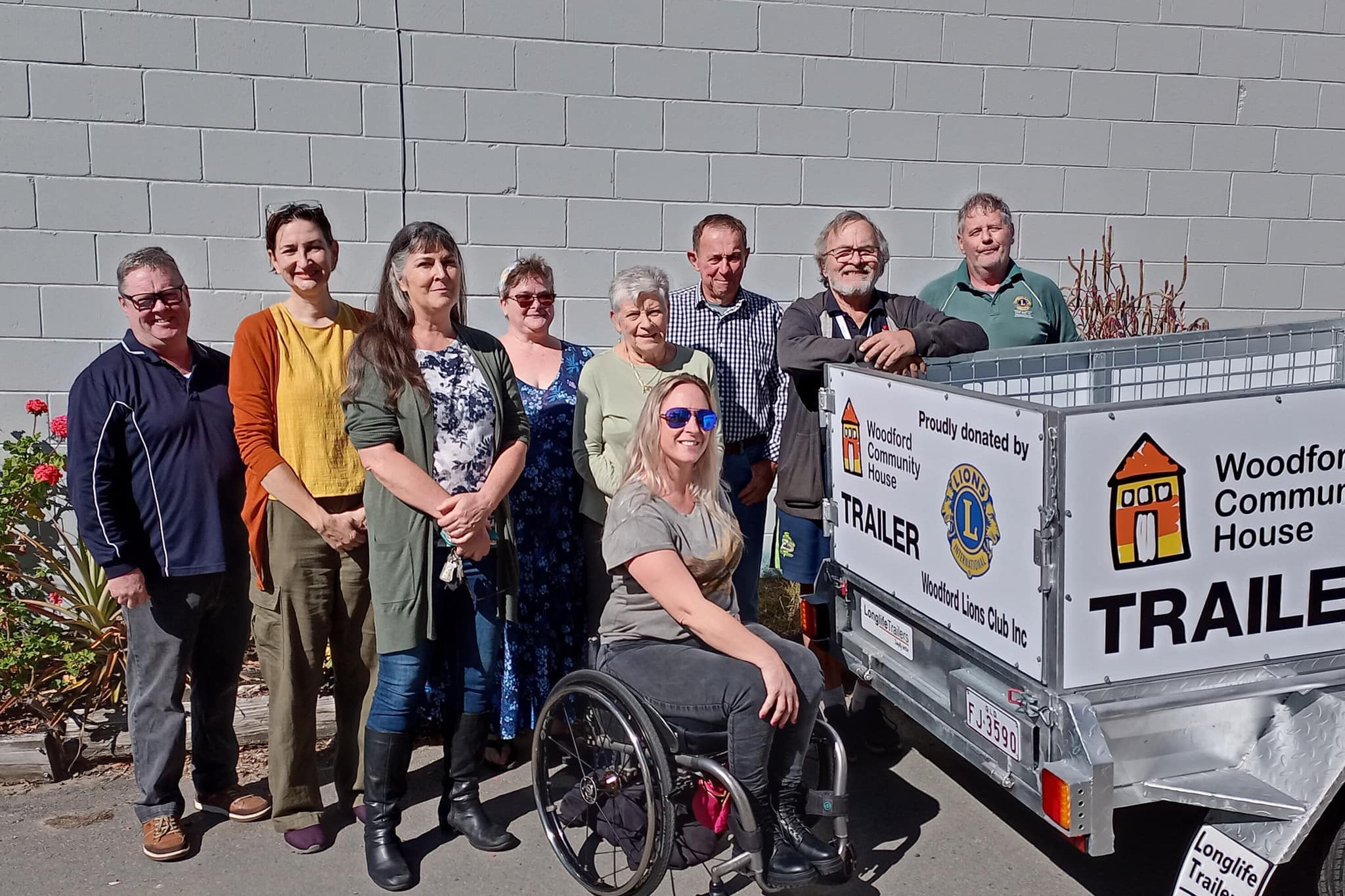 Members of the Woodford Community House and Woodford Lions Club with the new sign written box trailer, donated by the Lions to the Community House.