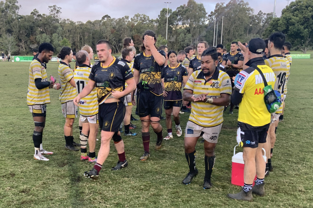 The Caloundra Lighthouses form a tunnel for the Caboolture Snakes, who exit the arena after suffering a 47-0 loss to Caloundra.