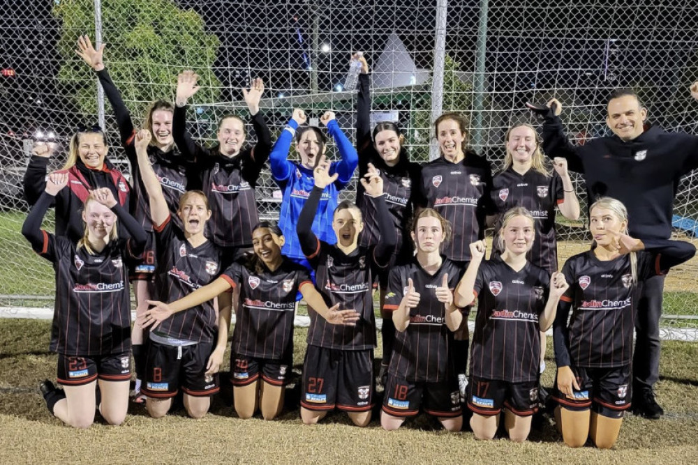 The Caboolture Sports FC Metro U23 women’s team rejoices after securing the ladder lead with four rounds still to be played. Co-coaches Tina Mawer (back left) and Andrew Aranovitch (back right) join in the celebrations. Photo credit: Prue Aranovitch.