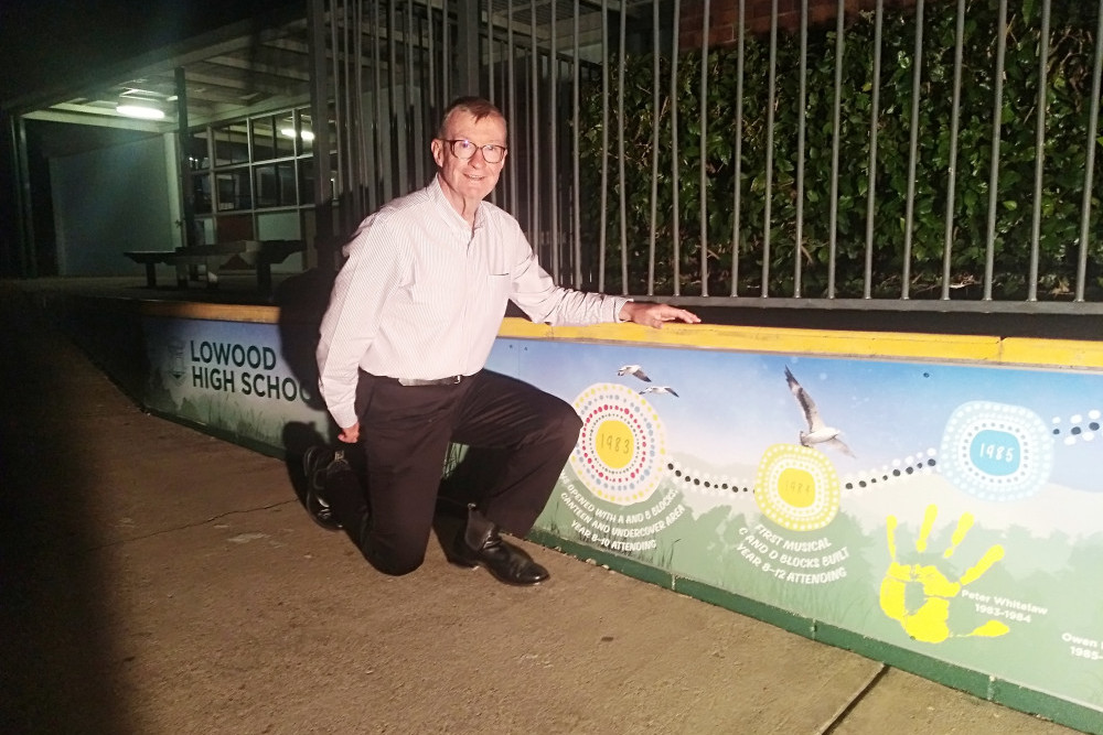 Lowood State High School foundation principal Peter Whitelaw, alongside the new mural at the school.