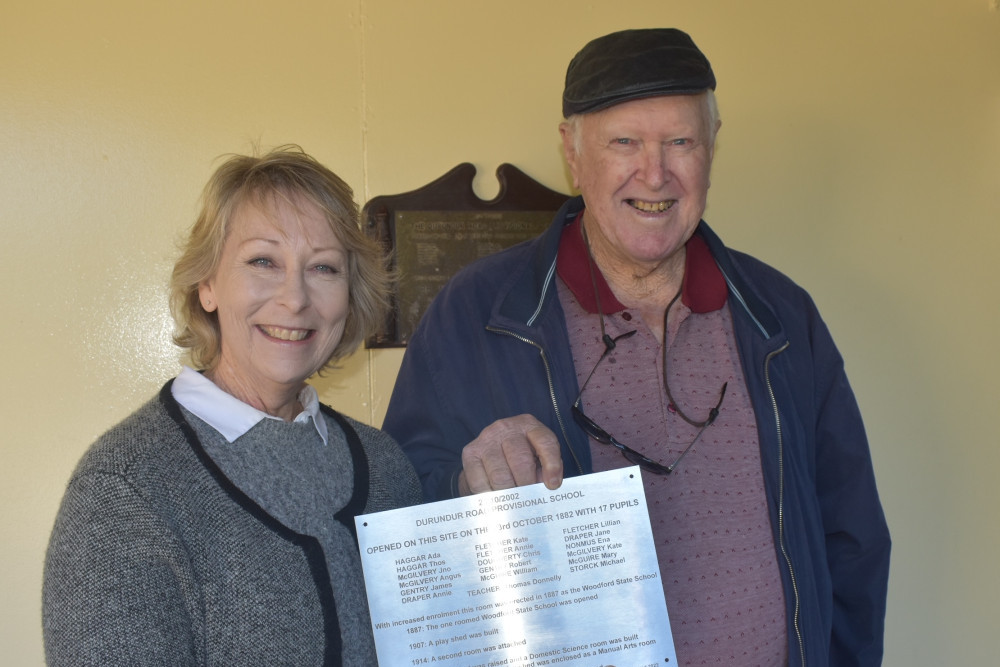 Woodford Historical Society president Ron Trim presents Woodford P-10 State School principal Bronwyn Raponi with one of the new plaques.