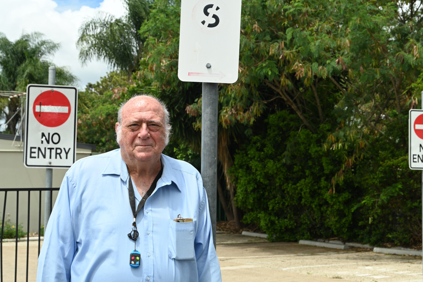 Barry Wilson with a parking sign not meeting the Australian Standards.