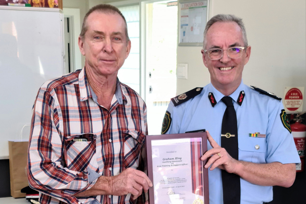 Graham King receives a Plaque for 26 years of service from Assistant Commissioner, John Bolger
