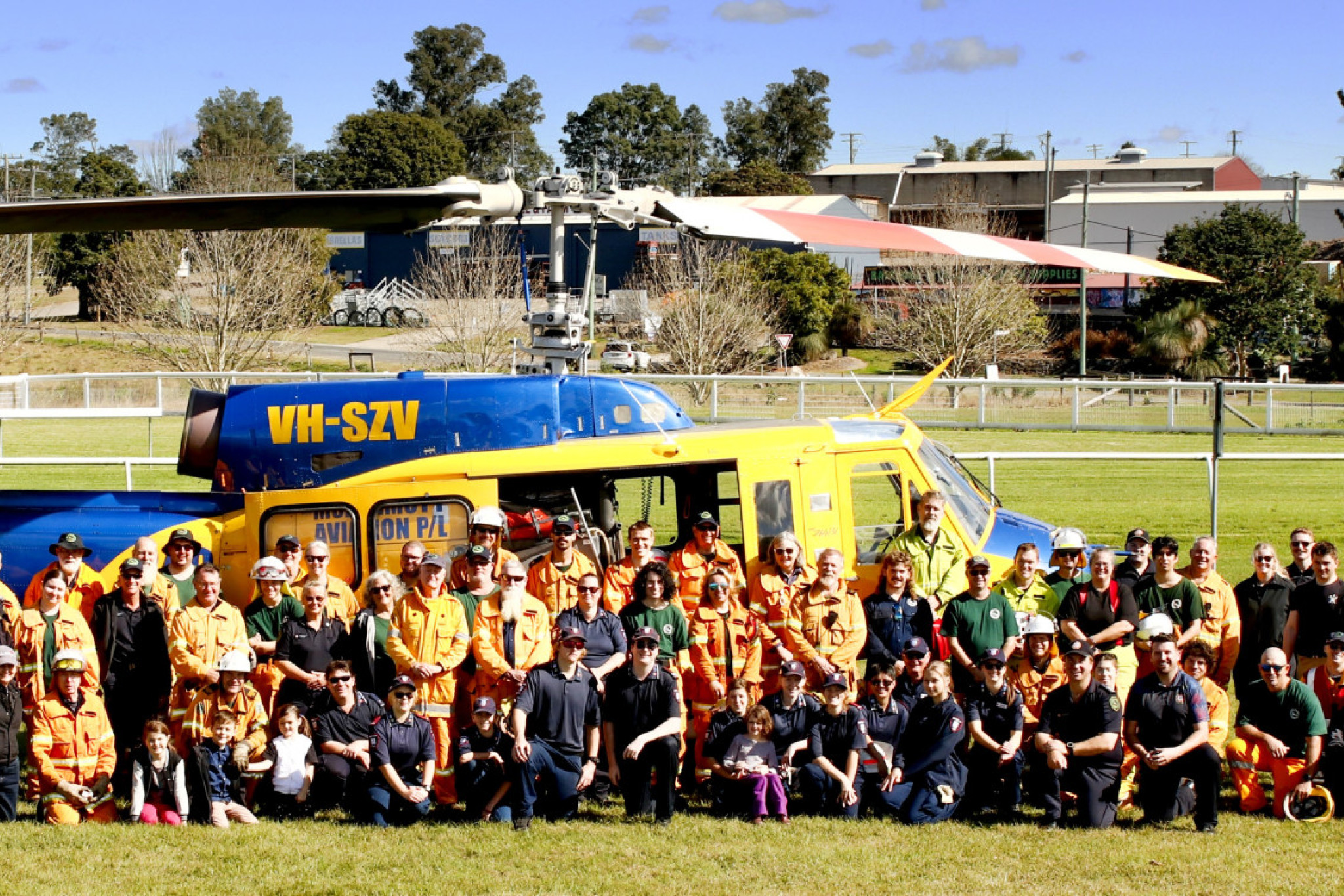 Group shot of all firefighters in front of water bomb heli-tac.