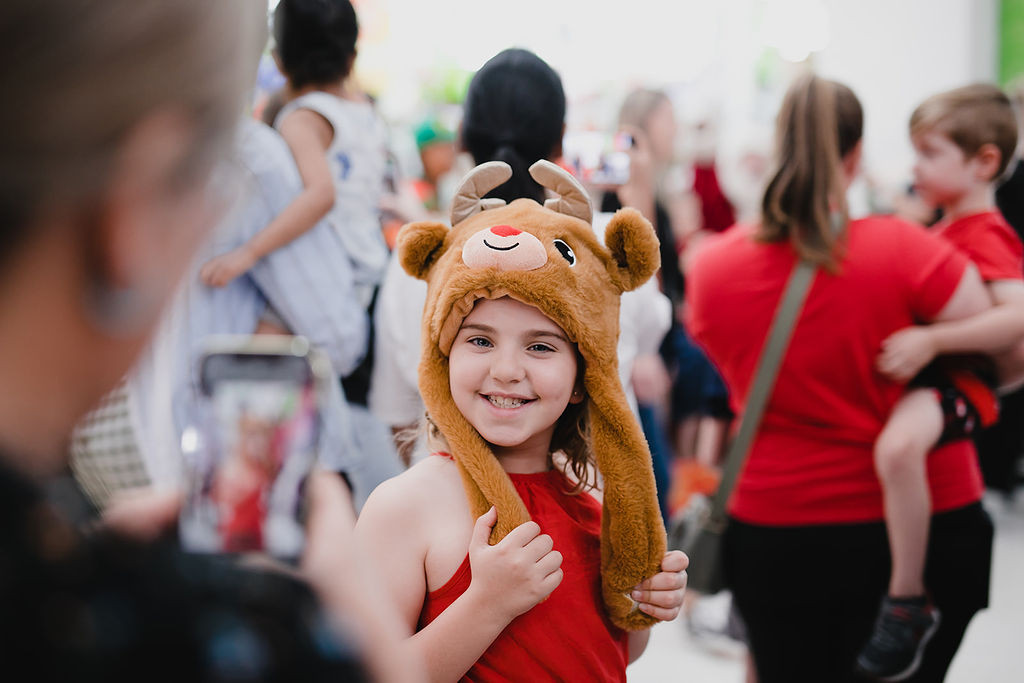 One of many smiling kids enjoying Santa’s Arrival Parade at Morayfield Shopping Centre.
