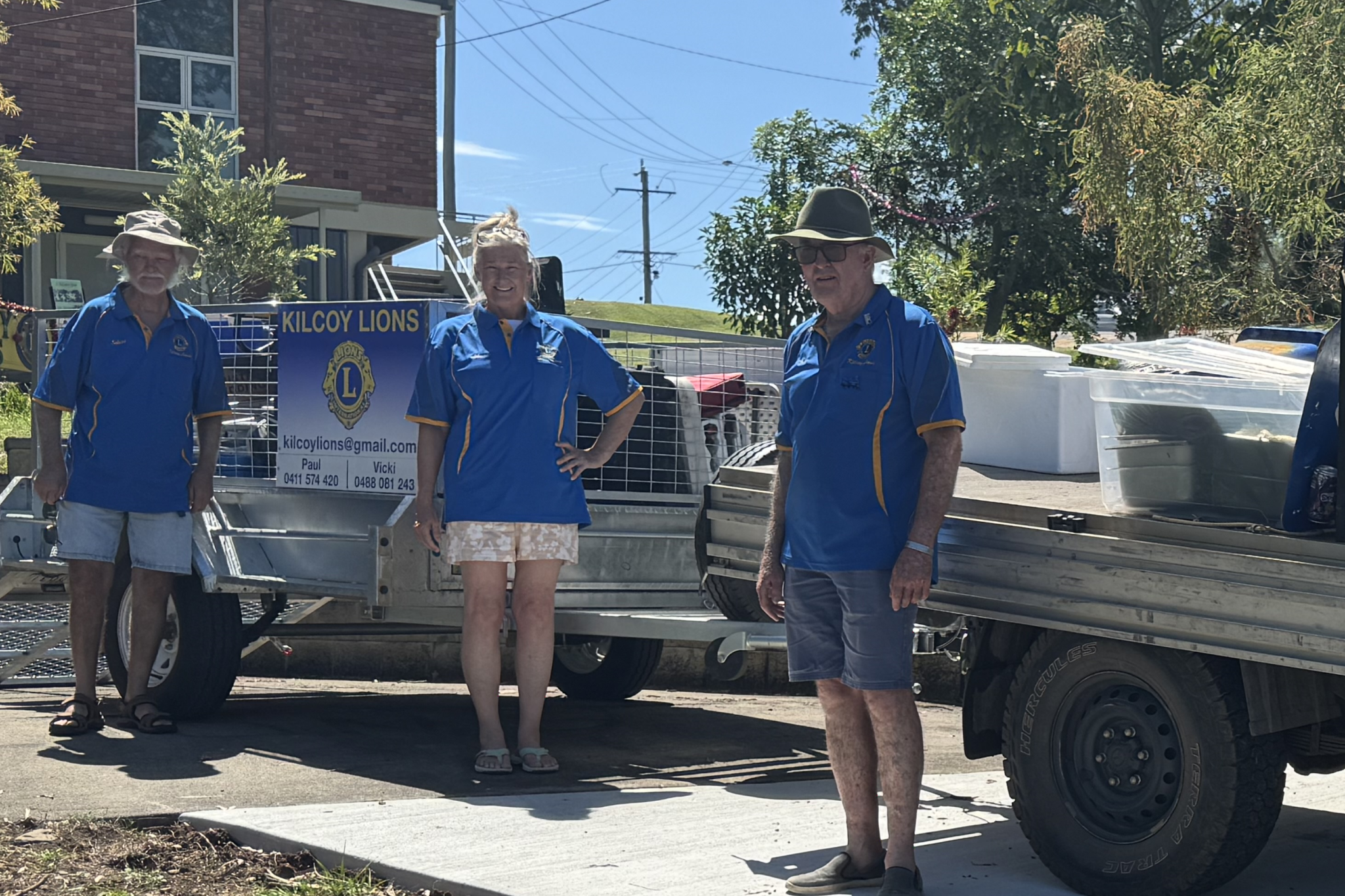 Treasurer Jeff Wildman, Laura Perry and President Paul Wilkes with trailer on new driveway.