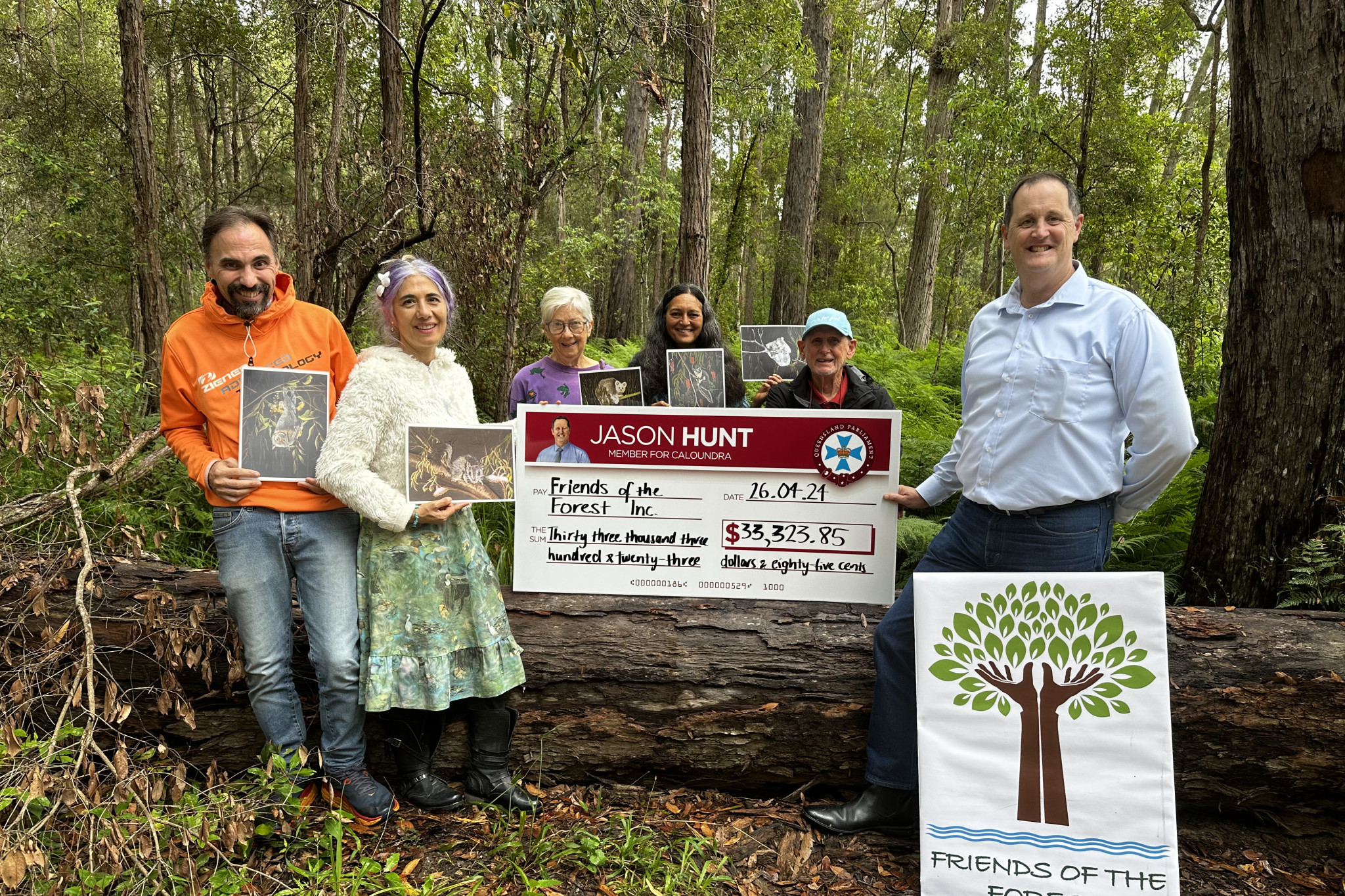 Jason Hunt presents a cheque to Friends of the Forest Inc.