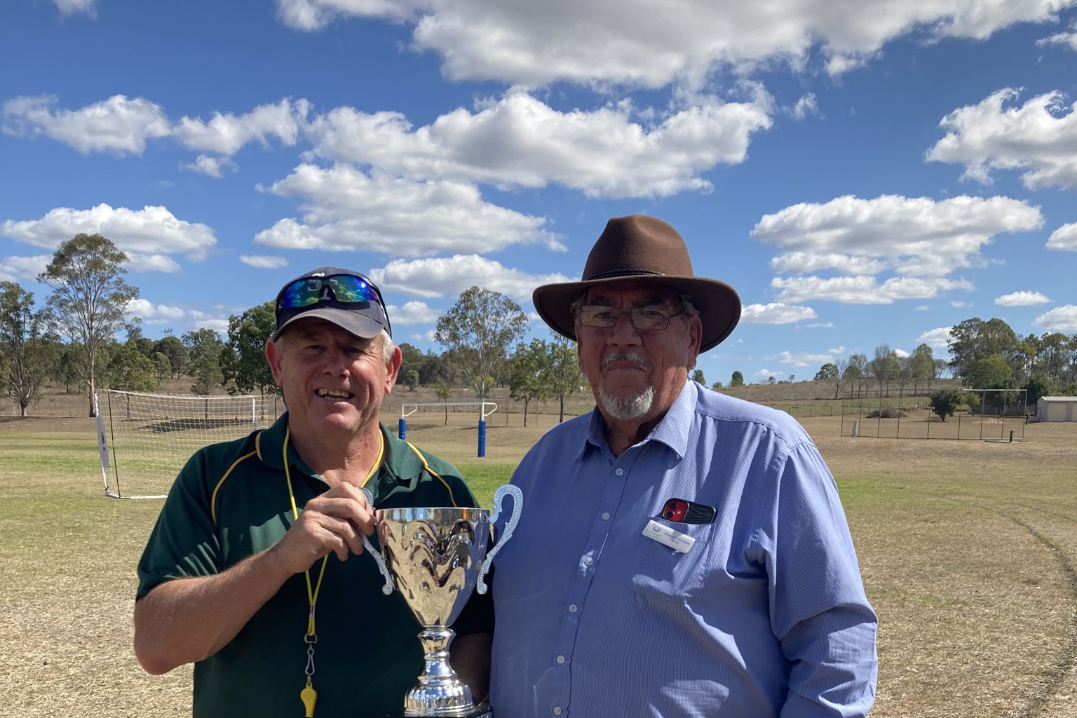 Principal of Toogoolawah State School with Mayor Graeme Lehmann get ready to present the Somerset Primary School Sports Cup.