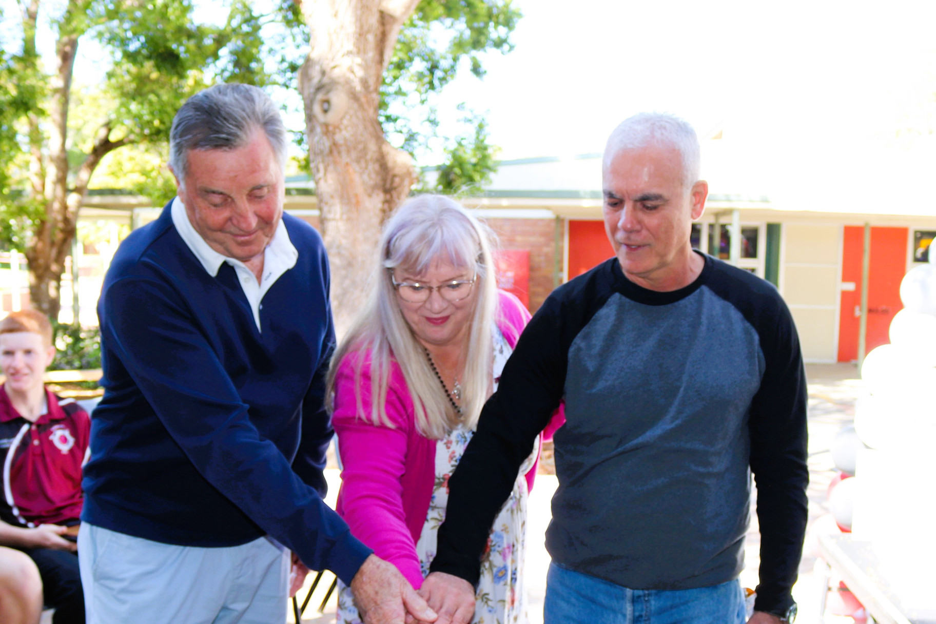 Foundation Principal, current Principal Kerrie Scott and foundation staff member Luigi Raponi cutting the cake.