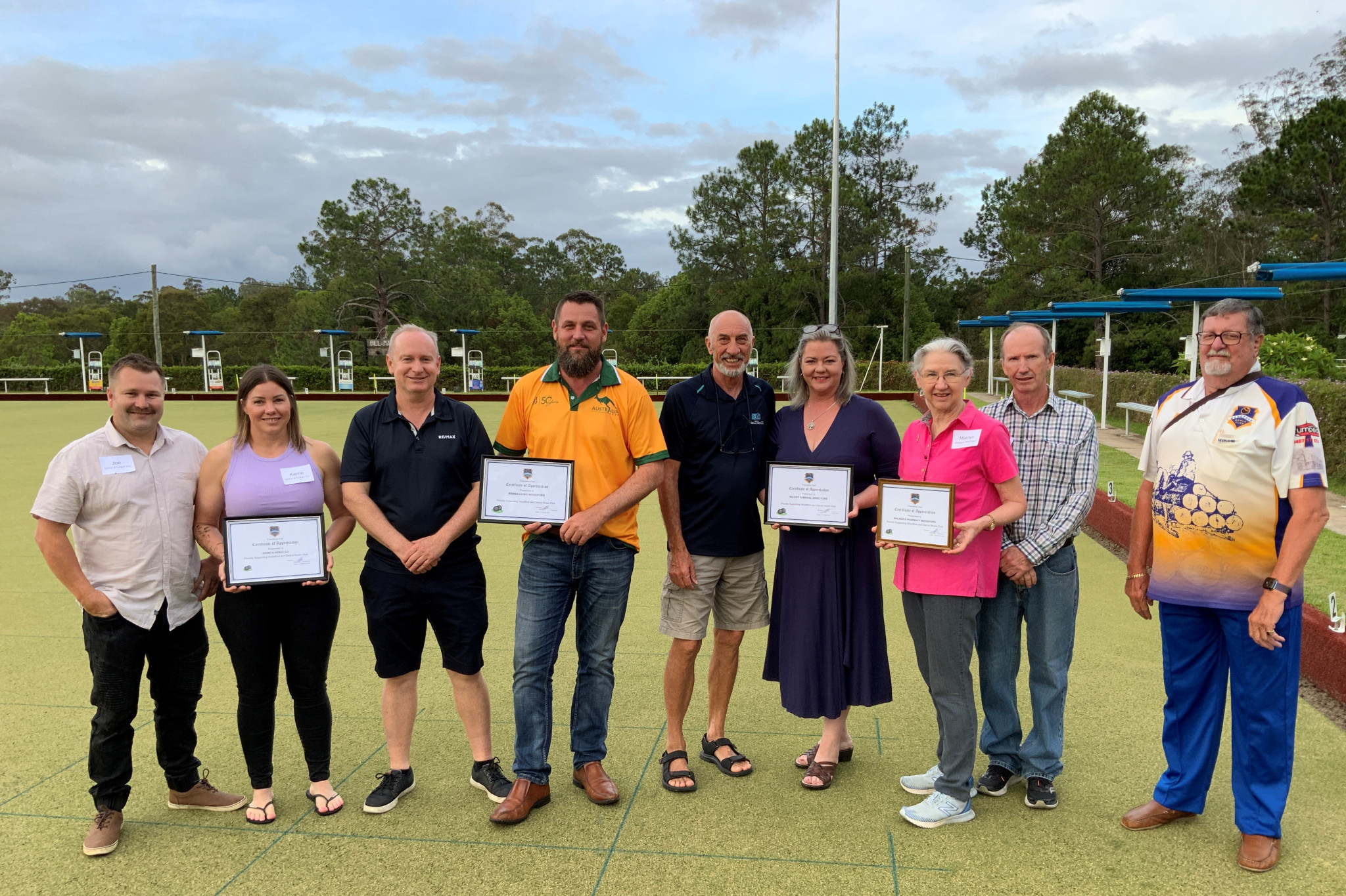 Joe VanScherpenseel, Kerri VanScherpenseel, Tim Facy, Chris Wease, Phillip Novella, Melissa Wyton, Marilyn Walker and Allan Walker (pictured with Ray Auer from the Woodford Bowls Club) were awarded certificates of appreciation before the Woodford Bowls Club unveiled its new floodlights.