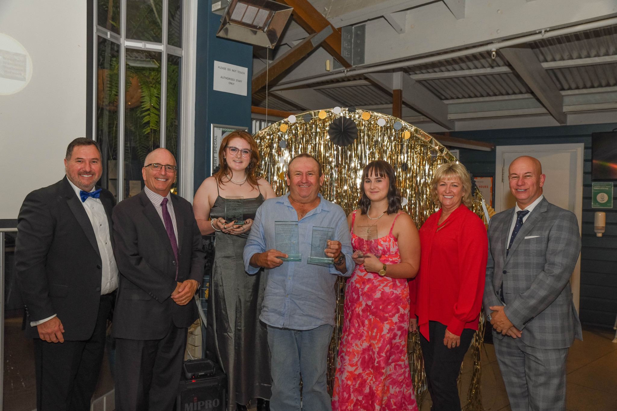 Andrew Powell MP (left ) and Steve Minnikin MP (right) with Moreton Bay winners: Bronze Employee, Maggie Upson from Sticks & Stones Espresso Bar (centre left ); Silver Employee, Makayla Bigalla from, Hair on Archer (centre right); and Gold Employee, Dick Howard from Woodford Home Timber & Hardware (centre), who also won Silver Business.