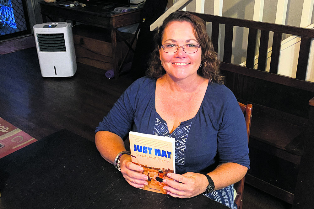 Author Natalie Kile with her debut book 'Just Nat', a biography of her friend Natalie Lowndes