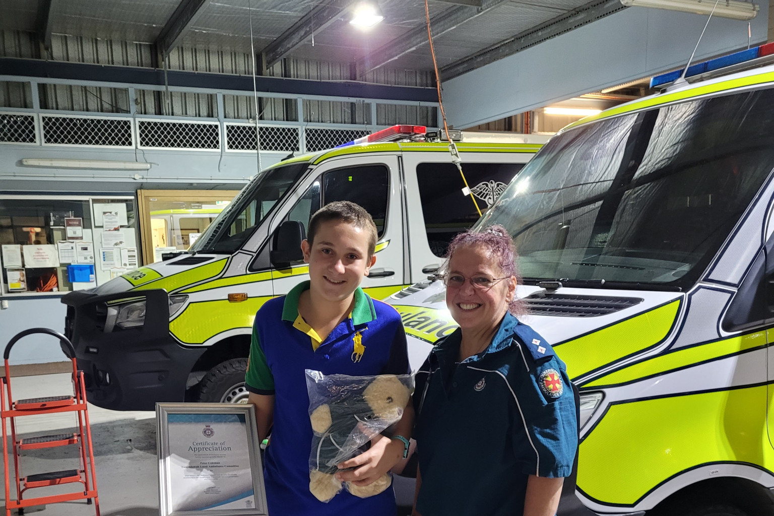 Peter Coleman and OIC Tanya King with certificate and bear.