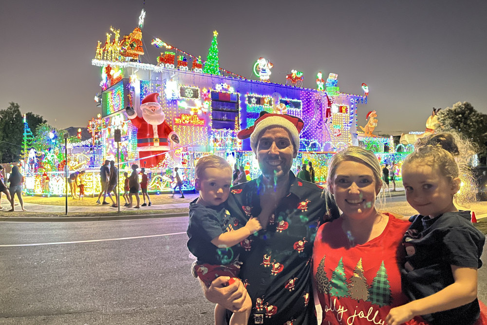 David and Chloe Strickland with their children Noah and Piper in front of their winning Christmas light display in Burpengary East.