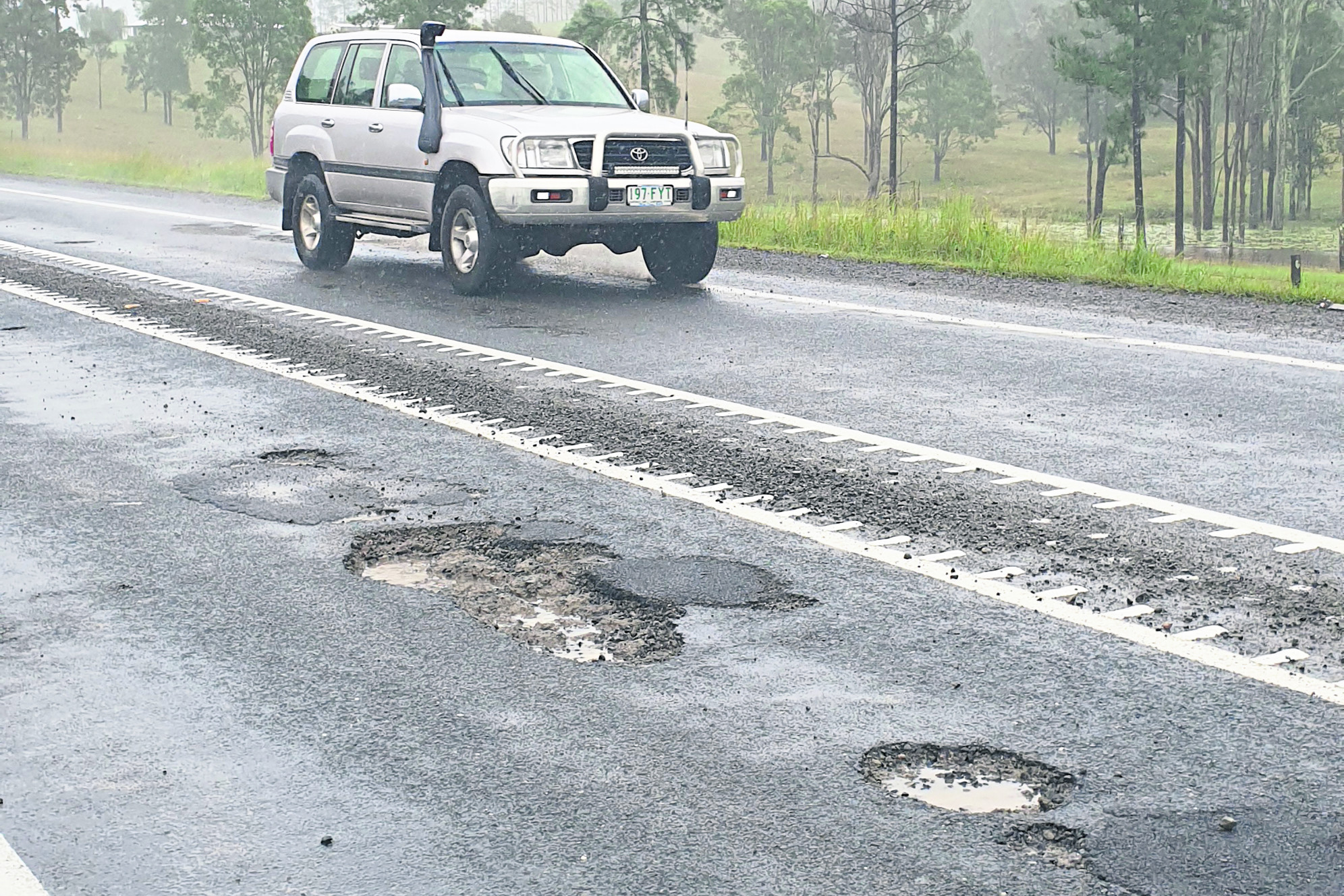 Potholes on the D’Aguilar Highway on Tuesday morning (6 April, 2021) near the Jenkinsons Road intersection (approximately 5km west of Woodford)