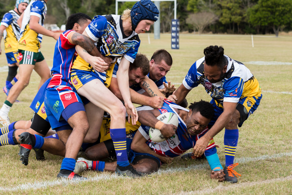 Among a pile of bodies, Keverieli Waqa has possession for the Kilcoy Yowies in their win on home soil last Saturday. Photo credit: Melinda Harrison/Deerlightful Photography.