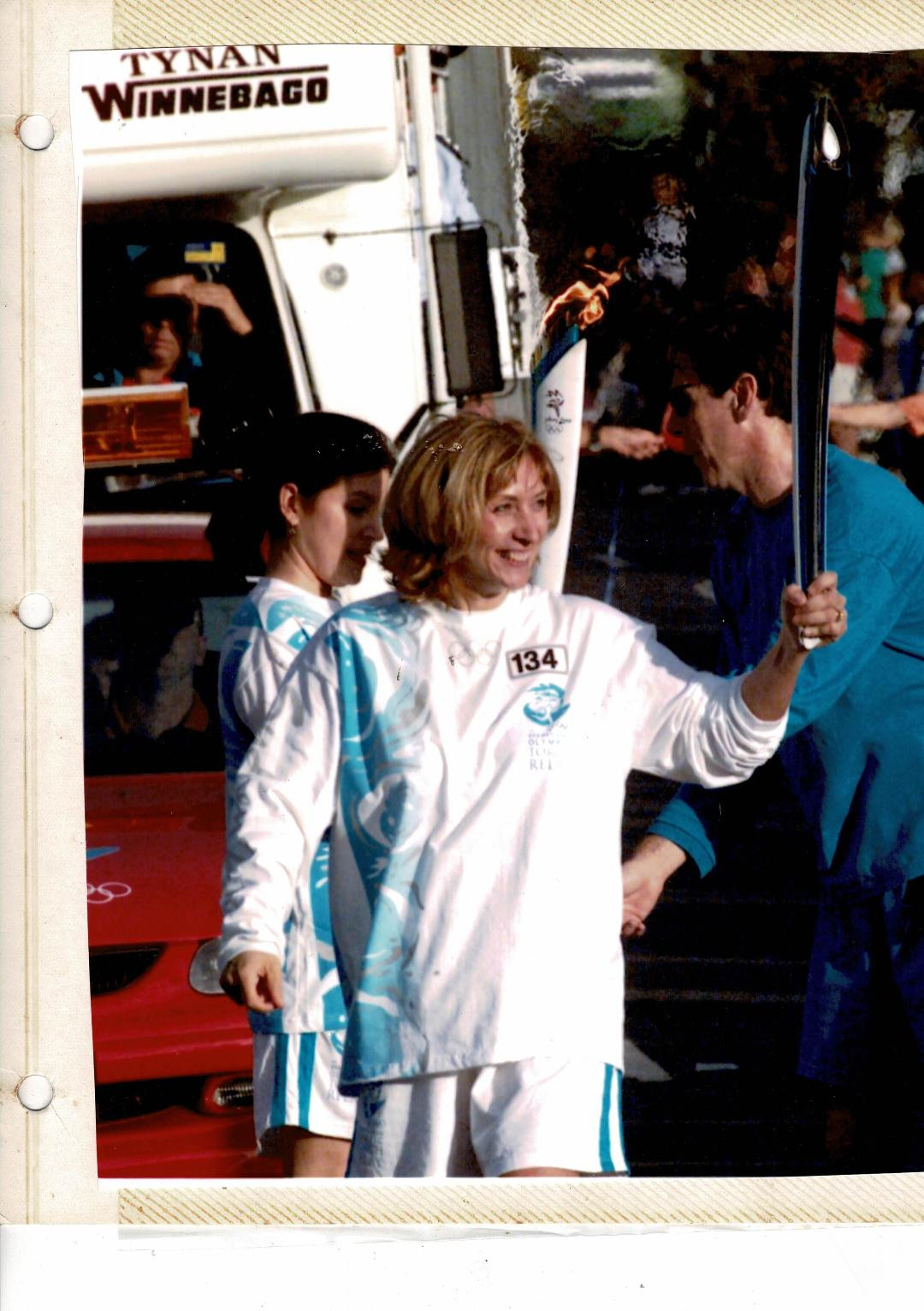 Jayne carrying the Olympic Torch in 2000 due to her voluntary work with kids.
