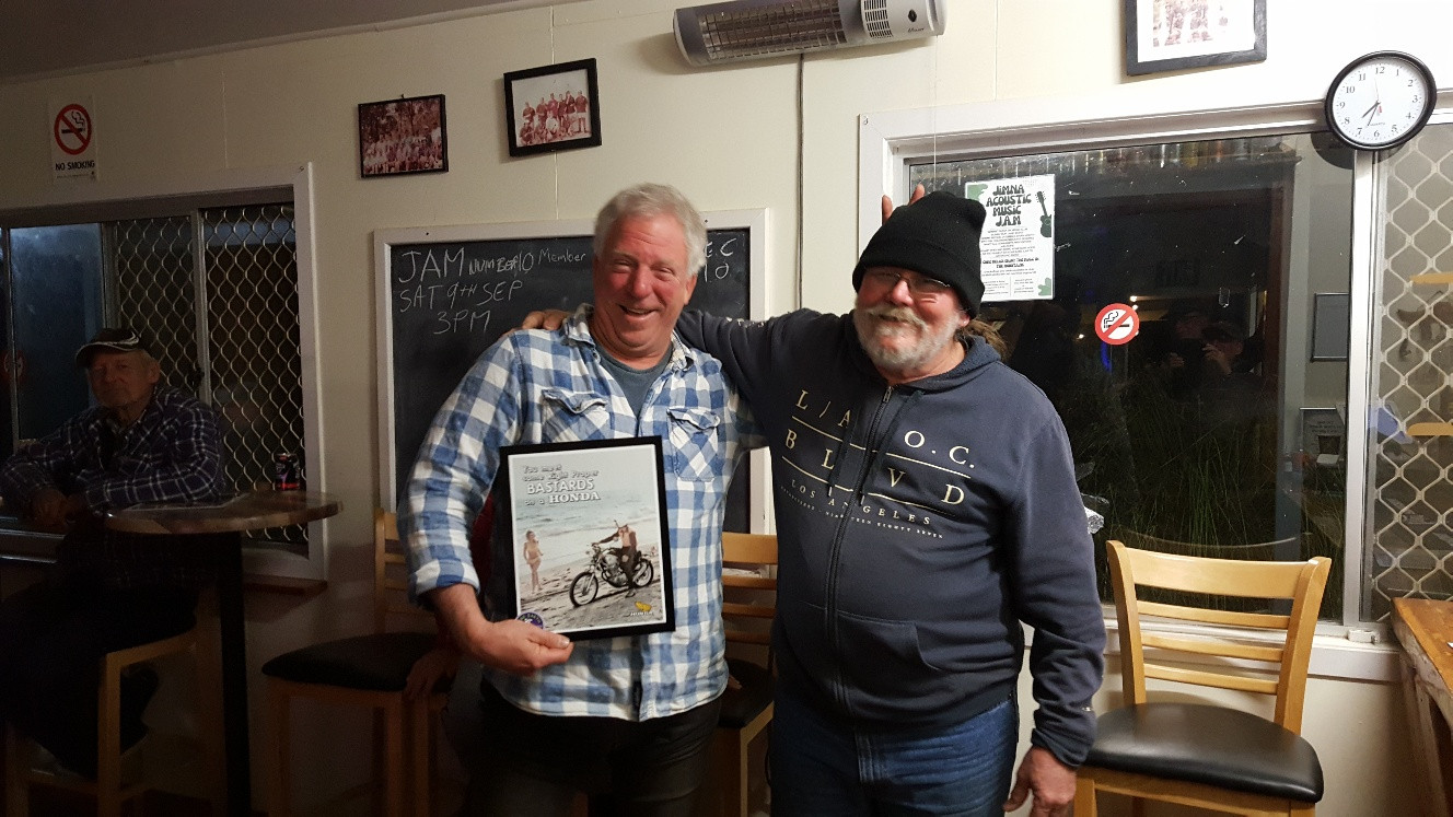 Phil Watson receives an award from Matt Rees for his vital help in organising the recent ride in and around Jimna.